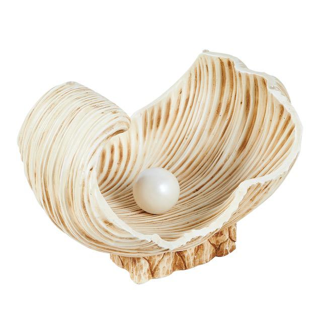 Rare sculptural coffee table with a sculpted oyster shell base holding a 4.5" satin-finish, solid "pearl." The beveled...