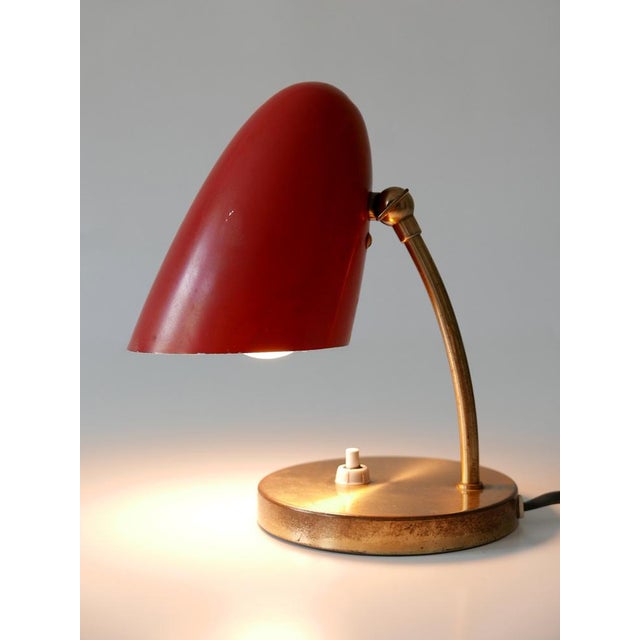 Elegant and highly decorative mid-century modern table lamp with adjustable shade. Designed and manufactured in germany,...