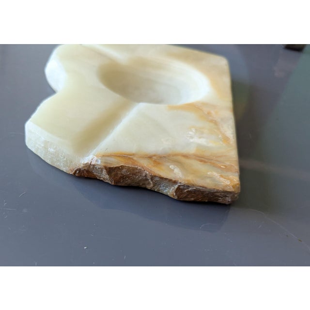 Beautifully sculpted maintaining natural edges revealing vibrant onyx colors, tans, browns.