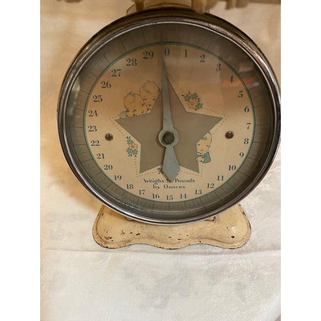 This is an adorable baby scale from the early 20th century.