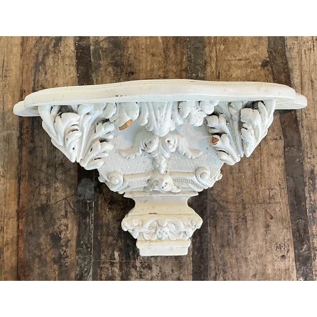 This exquisite pair of vintage carved wood wall brackets brings a touch of Neoclassical grandeur and Hollywood Regency...