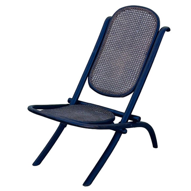 Victorian child-size Thonet number 01 folding chair with woven cane seat and backrest. It features an elegant, sculptural...
