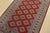 A tribal Bokhara Jaldar rug hand-knotted with fine wool on a cotton foundation. This rug features rows of repeating...