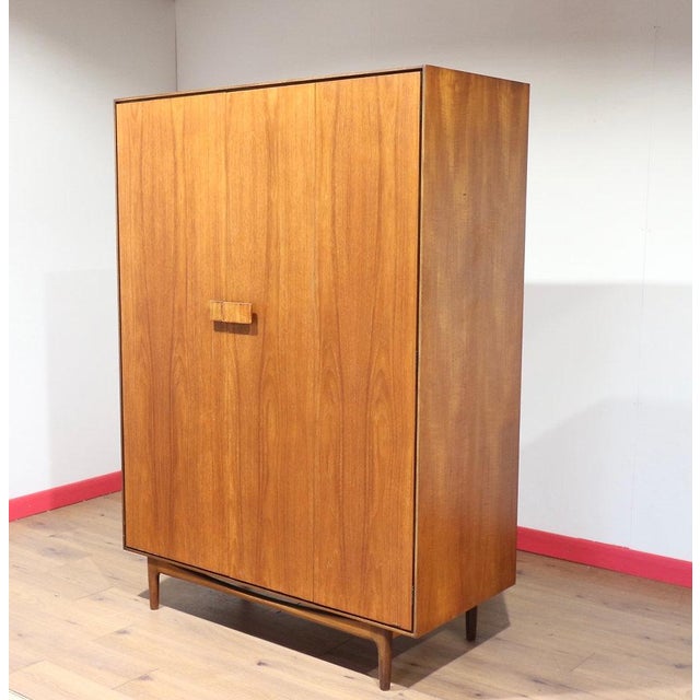 A beautiful mid century armoire made by renowned British furniture maker G Plan as part of their Danish range and designed...