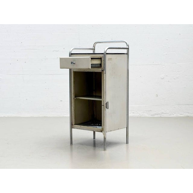 This bedside table, with its characteristic bauhaus influence, is from a. Farina, lissone, italy, a manufacturer that...