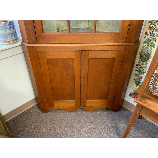 Circa 19th Century American federal style corner cabinet. Cherry wood, original glass. Two- part construction.Pie shape...
