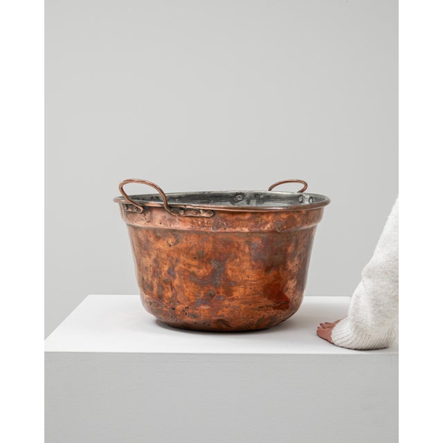 This 19th-century Belgian copper pot showcases expert craftsmanship and utilitarian elegance. Hand-hammered from solid...