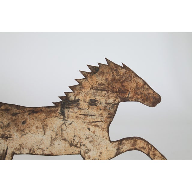 Vintage rustic Folk Art metal horse on board. No makers mark. Age wear to painted finish.