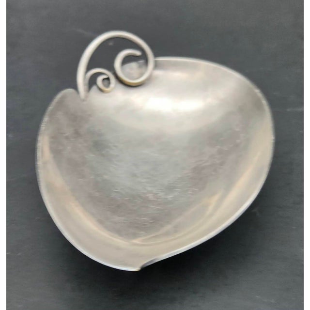 Offered is a mid 20th Century (circa. late 1950s) silver-plated leaf-shaped trinket dish made in Denmark. Measures: 4.75"...