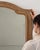 A circa 1900 French wall mirror in the Louis Philippe style, featuring a vertically oriented frame with softly rounded...
