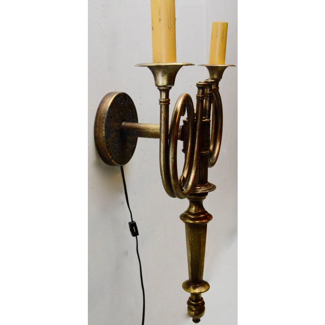 This is a gilt finish electrified wall sconce with two hunting Horn style accents. The piece features two candlestick...