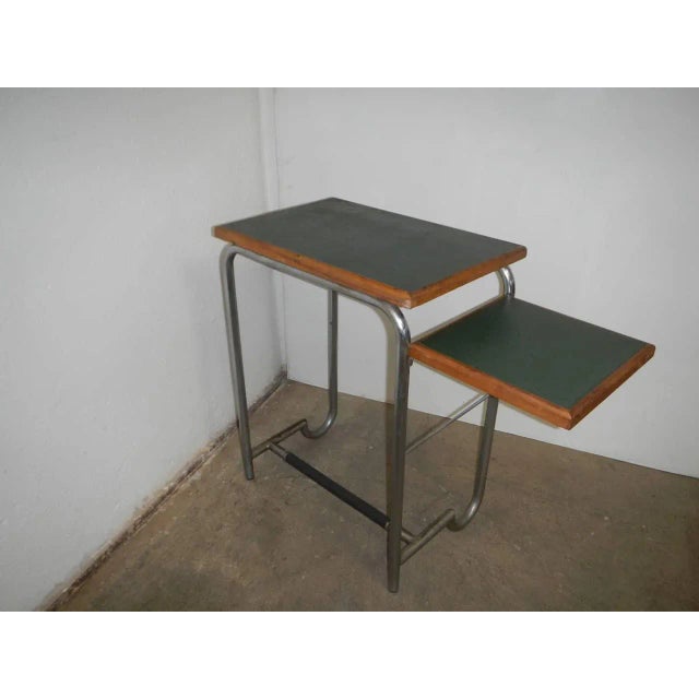 The side table is retractable. The structure is made of bent iron tube. This piece has an attribution mark, I am sure that...