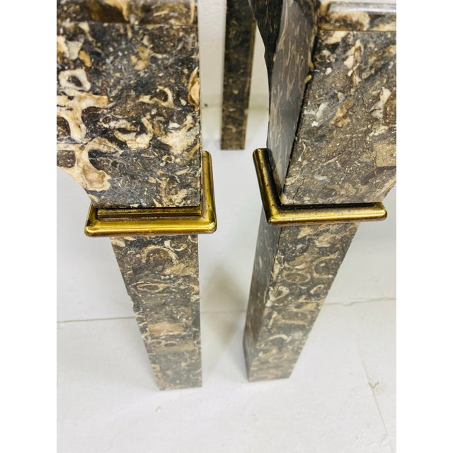 This is a handsome pair of vintage marble side tables. The tables have a parsons style leg with solid brass detail at the...