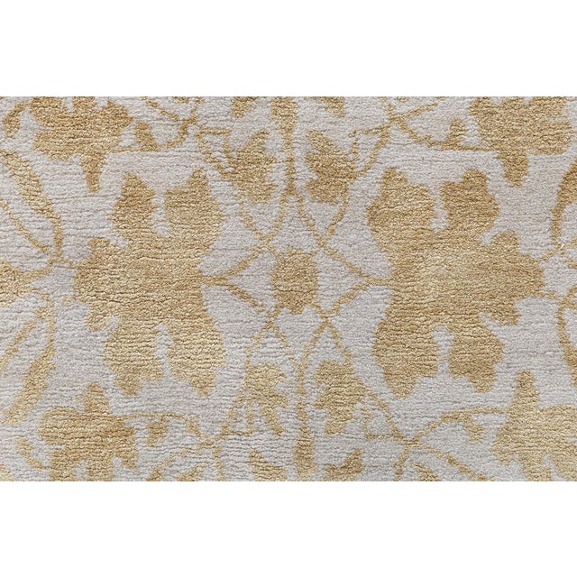 This exquisite Tibetan rug is a luminous marriage of craftsmanship and elegant design. Measuring 9 by 12 feet and hand-...
