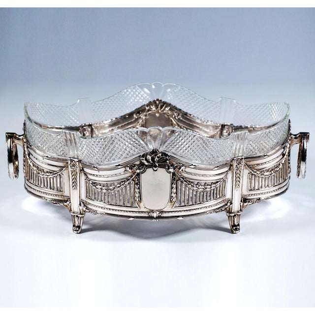 Elegant silver jardinière in an elongated quatrefoil shape, the sides divided by four pilasters featuring floral and...