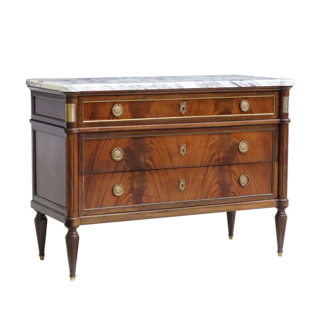 An incredible French Louis XVI Style Mahogany Marble Commode with design attributed to Maison Jansen Directoire Style. The...