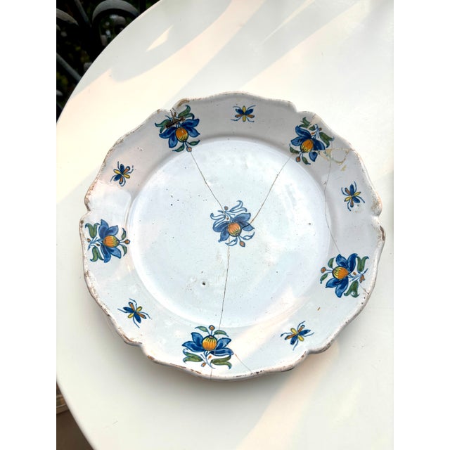 A charming pair of antique French tin-glazed earthenware plates dating from the 18th century, likely produced in the south...