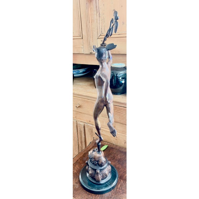 An impressive, large-scale vintage patinated bronze sculpture of the "Flying Mercury" (Hermes) 30 inches tall. This piece...