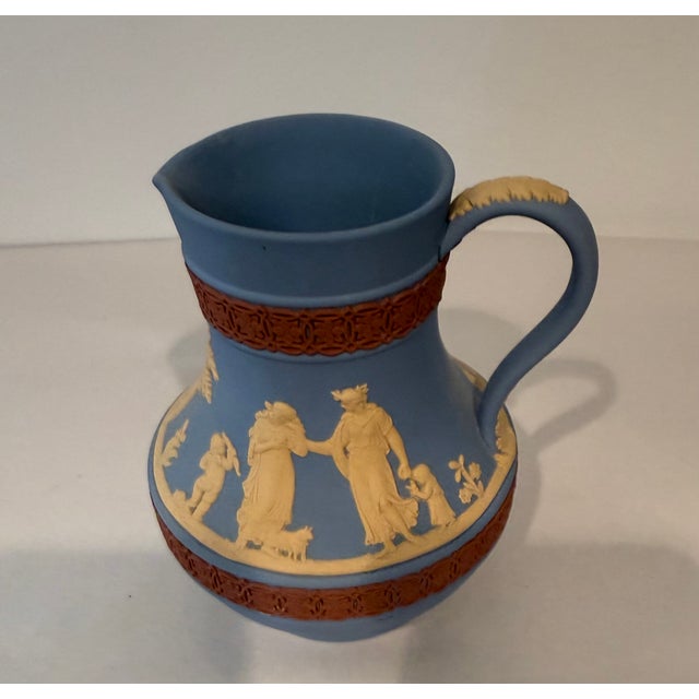 Beautiful tri-color Wedgwood Jasperware pitcher in blue, terra cotta and cream. Vessel is 5.25" high and 2.75" across at...