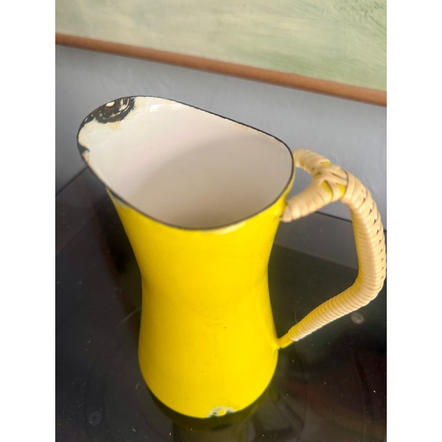 Dansk metal enamel pitcher with lanyard woven handle. Designed by Jens Quistgaard and made in Denmark. Marked with stamp...