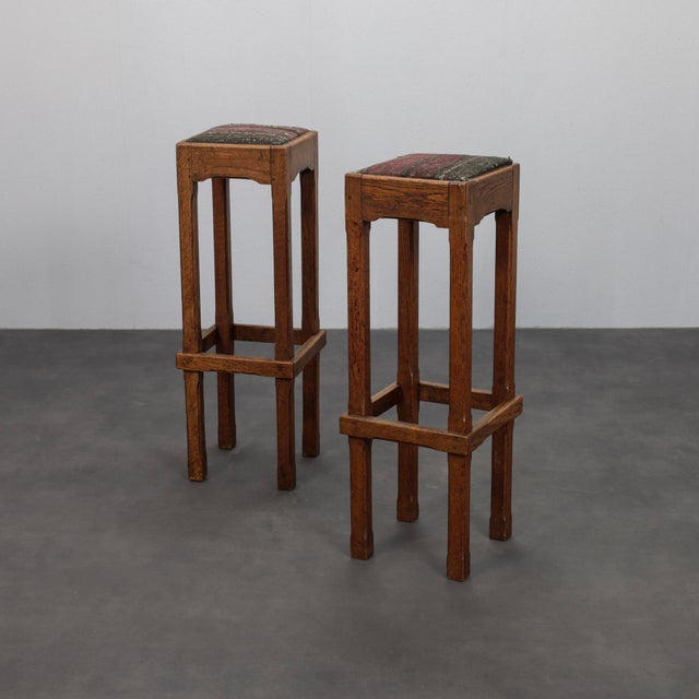 A refined pair of dutch art deco bar stools dating from the 1930s, crafted from solid oak and retaining their original...