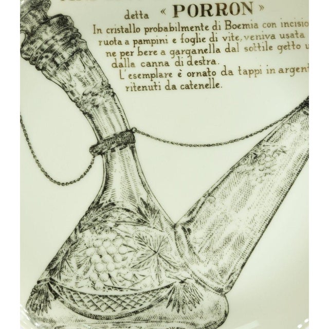Porron is a silk-screened porcelain plate, designed by Piero Fornasetti for Martini & Rossi in 1960s. Excellent...