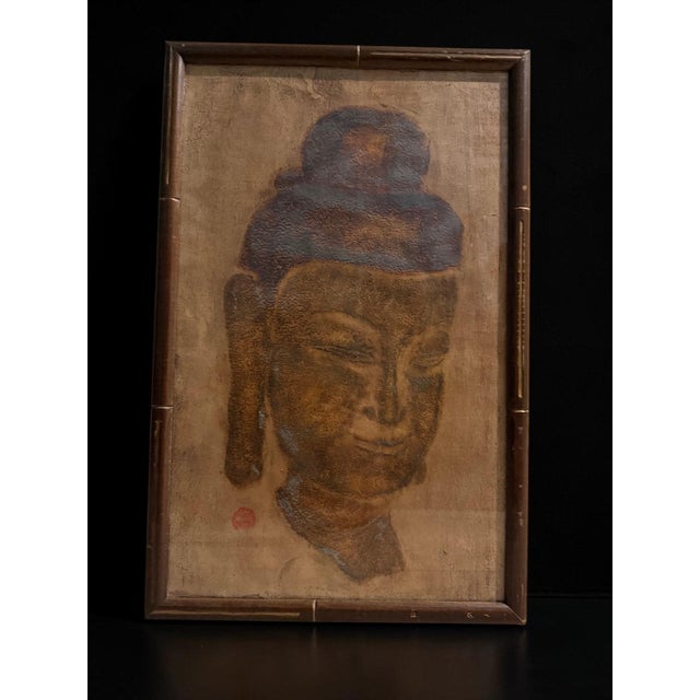 Beautiful framed Buddha temple stone rubbing featuring a serene Buddha portrait in earthy bronze, brown, and charcoal...