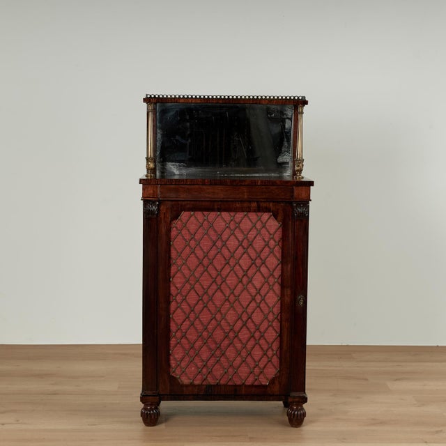Handsome 19th century English chiffonier handcrafted in rosewood featuring a brass gallery on the top shelf supported by...
