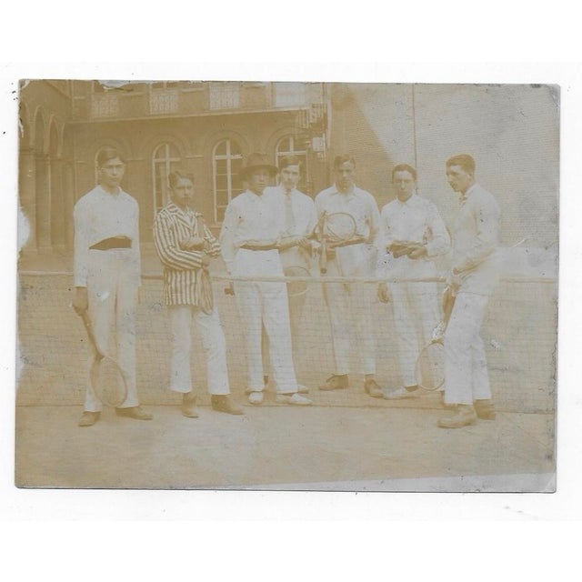 Late 19th century antique photograph of a tennis team in a courtyard.