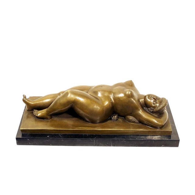 This solid bronze sculpture depicts a reclining nude woman in a restful pose, illustrating the fascination with volume and...