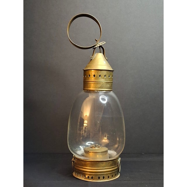 An exceptional and unusually heavy antebellum American brass fixed-globe hand/marine lantern, dating to circa 1840–1855....