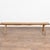 20th-century rustic bench constructed with a lighter pine plank seat and darker oak peg and splay legs, reflecting...