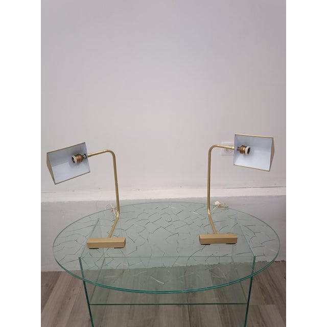 A beautiful pair of lamps attributed to Cedric Hartman. USA, 1960s. All brass construction. The arm pivots 45° to either...