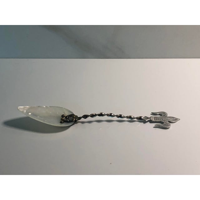 Serve your caviar in style with this lovely Antique Mother of Pearl Sterling Fleur De Lis Caviar Spoon. The fleur de lis...