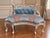 This elegant 1970s French Louis XVI–style settee combines refined neoclassical detailing with a softly luminous antique-...