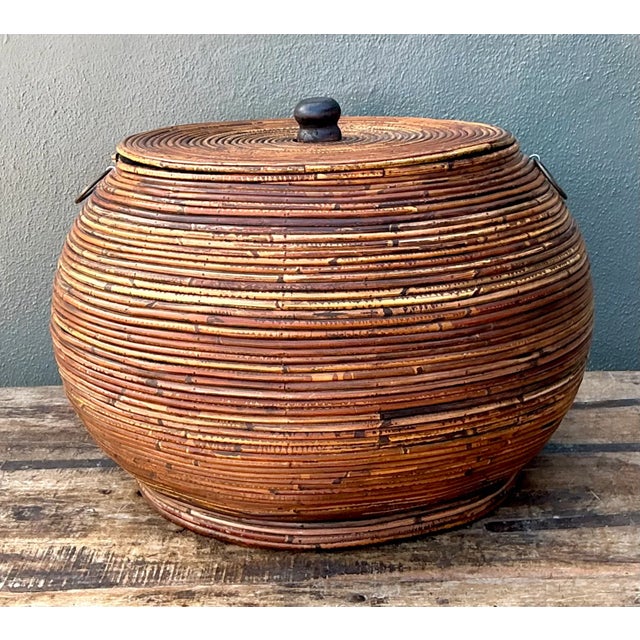 With its rounded form and warm amber patina, this vintage pencil reed lidded basket brings natural texture and relaxed...