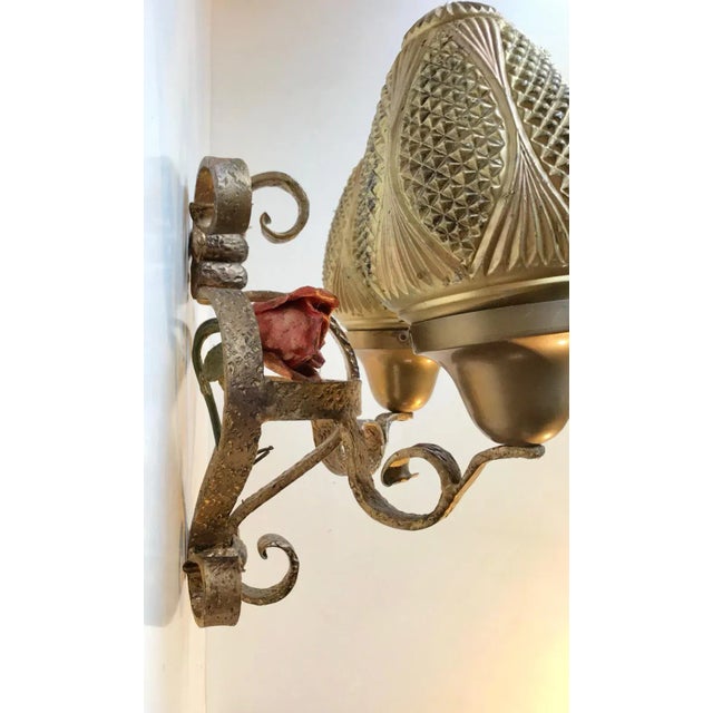 A hand welded wrought iron sconce with two painted glass shades. It was originally made in France circa 1920-25 and...
