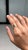 This handcrafted bypass solitaire ring showcases a 0.7 carat natural oval zambian emerald, set in 14K yellow gold. The...
