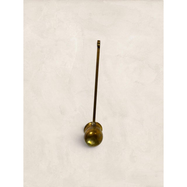 A charming antique brass rum or spirit ladle featuring a deep bulbous bowl and an exceptionally long wire handle with a...