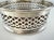 A beautiful vintage wine and decanter coaster featuring an intricately pierced silverplate gallery surrounding a richly...