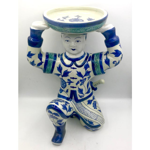13" Tall hand painted blue and white Chinese figurine of imperial palace man with long braid and sword holding plate....