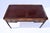 An early 20th c. Louis XVI style leather top desk with three drawers, original brasses and tapered reed legs; by Cassard...