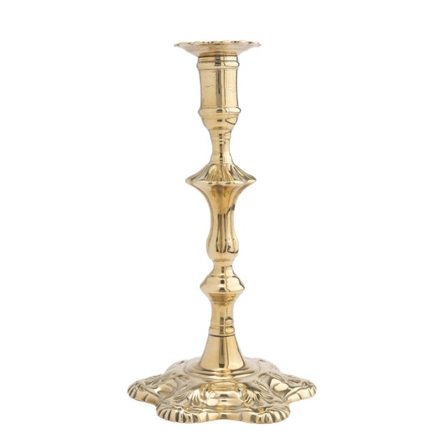 Queen Anne seam cast brass candlestick. The candlestick features a removable scolloped edge bobeshe on an urn form candle...