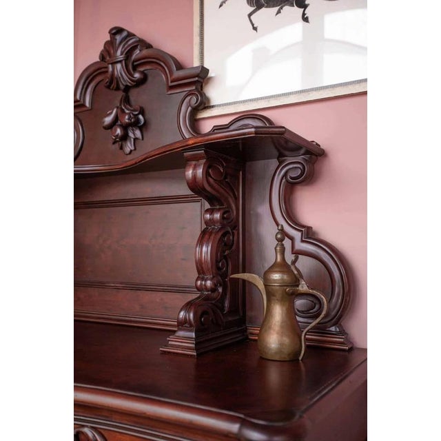 Buffet made of solid oak refined with mahogany veneer and hand-carved solid mahogany. The buffet was made in the second...