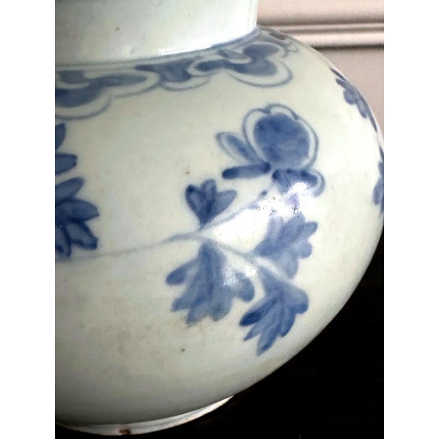 A Korean white porcelain jar with underglaze blue painting of large peonies with leaves circa second half of 19th century,...