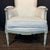 Elegant pair of antique French Louis XVI bergère armchairs featuring beautifully carved and painted wood frames with...