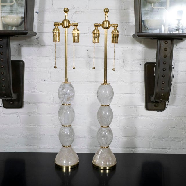 Pair of polished rock crystal table lamps with brass hardware.