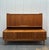 Very unusual mid century modern Danish Teak credenza with hutch top. Tambour sliding doors and mini bar in the center on...