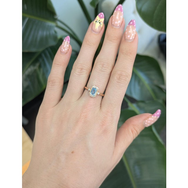 A beautiful 1.2 Ct natural Aquamarine in a classic 7×5mm emerald cut, framed by sparkling earth-mined diamond accents for...