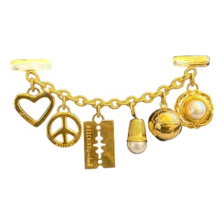 1980s Iconic Black Fabric and Brass Charms Clutch by Franco Moschino For Sale